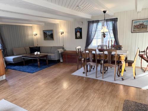 a living room with a dining table and a couch at Private pearl in downtown Røros in Røros