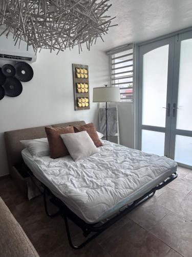 a bedroom with a large bed with a chandelier at Daisy'Hause 2 to 6 people, ideal for your family in Carolina