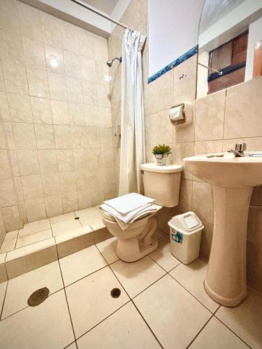 a bathroom with a toilet and a sink at Tambo Real Valle Sagrado in Yucay