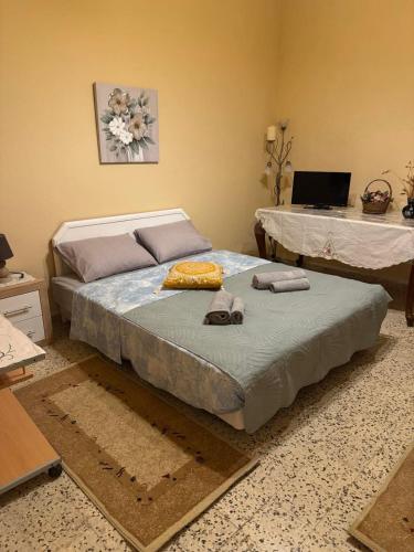 a bedroom with two beds and a laptop on the wall at Traditional Villa Stella in Archangelos