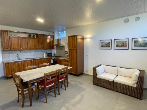 a kitchen and dining room with a table and chairs at LA MUELE Affittacamere in Gemona del Friuli