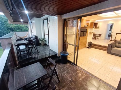 a view of a house with a patio and a living room at Varandas do Atlântico in Guarujá