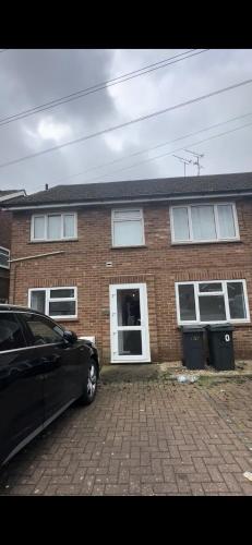 a car parked in front of a brick house at Cosy 2-Bed Maisonette in Ashford in Kennington