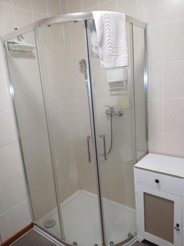 a shower with a glass door in a bathroom at Les 4 Portes in Le Mesnillard