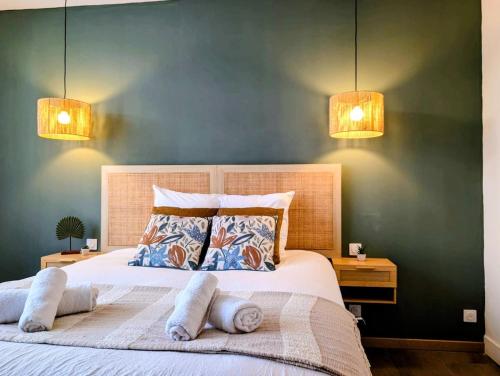 a bedroom with a large bed with two lights at Le 1930, la pause Béthunoise in Béthune