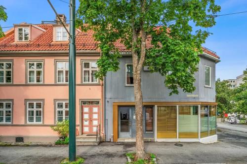 トロンハイムにあるSpacious and modern apartment in the heart of the cityの前に木がある家