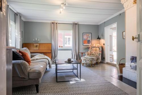 a living room with a couch and a table at Annexet Orrabackens in Järvsö