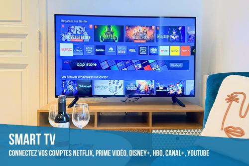 a flat screen tv sitting on top of a table at Studio Boho-Chic en centre ville in Moulins