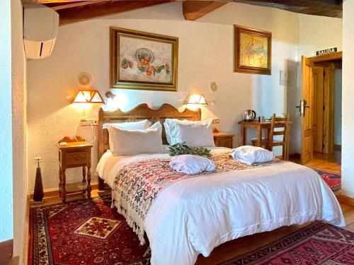 a bedroom with a large bed with two pillows on it at Hotel Peruskenea in Jaunsaras