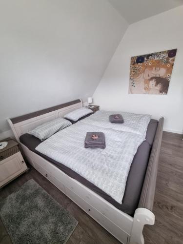a bed in a white room with avertisementatronatronatronstrationstration at Ferienwohnung Wienstroer in Westbevern