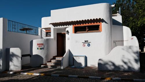 a white house with stairs in front of it at HolaCamp Gandía in Daimuz