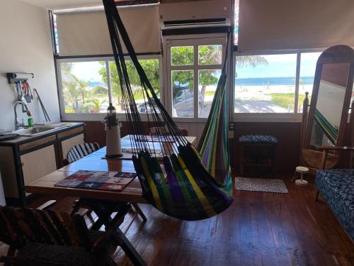 a hammock hanging in a room with a table at Loft del mar in Ciudad del Carmen
