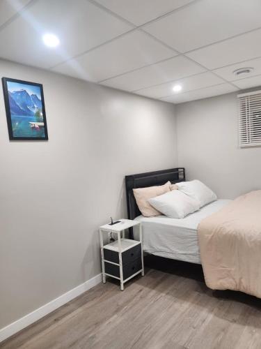 a bedroom with two beds and a picture on the wall at Elegance Lounge in Winnipeg