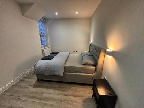 HanwellにあるLuxury 1BR Modern Flat in London W7 with Private Parkingのベッドと窓のある小さな寝室