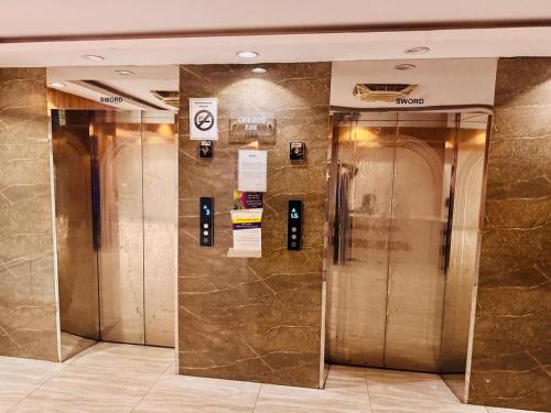 a row of elevators in a building at 1BR Cozy Apartment, Diamond Mall & Residencia, Islamabad in Islamabad