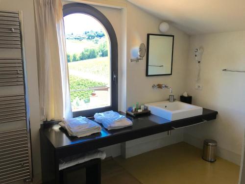 a bathroom with a sink and a window at Locanda Palazzone in Orvieto