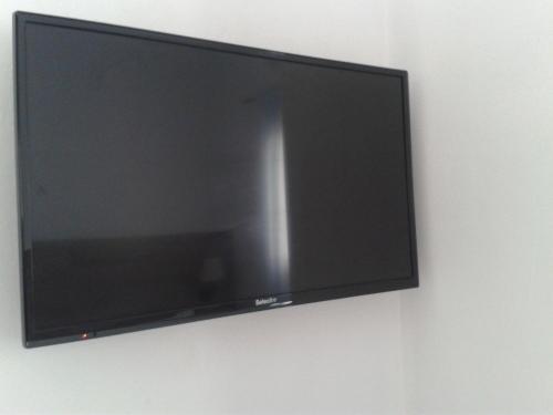 a flat screen tv hanging on a wall at La Chanca in Conil de la Frontera