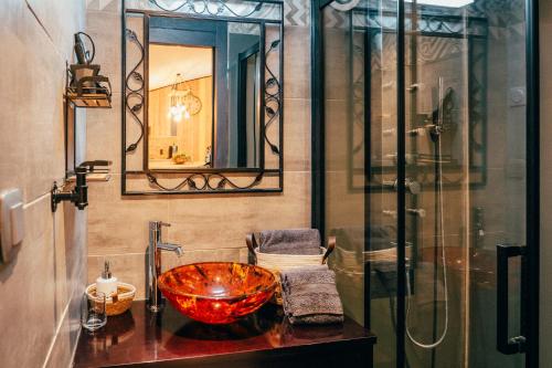 a bathroom with a bowl sink and a shower at La Grange in Sablons