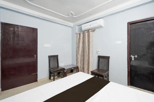 a bedroom with a bed and two chairs at Hotel O STAR GALAXY in Bhauli