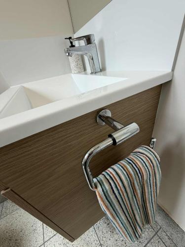 a bathroom sink with a towel hanging from it at Red Hill Cabin#2 - 2-bedroom in Walcha