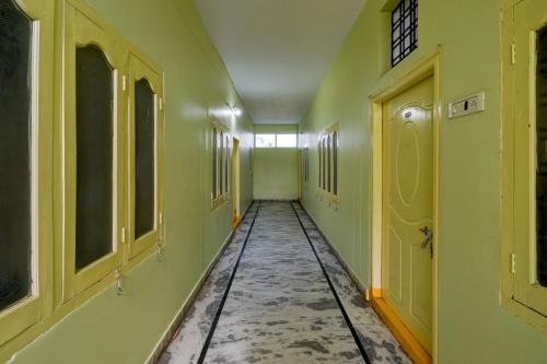 een lege hal met groene muren en een tegelvloer bij SPOT ON Harshitha Guest House in Pedda Ambarpet
