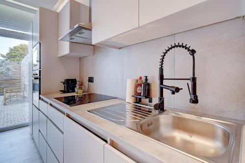 a kitchen with a sink and a counter top at L'Escapade in Liège
