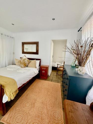 a bedroom with a bed and a blue desk and a table at Beachfront Apartment in Tergniet