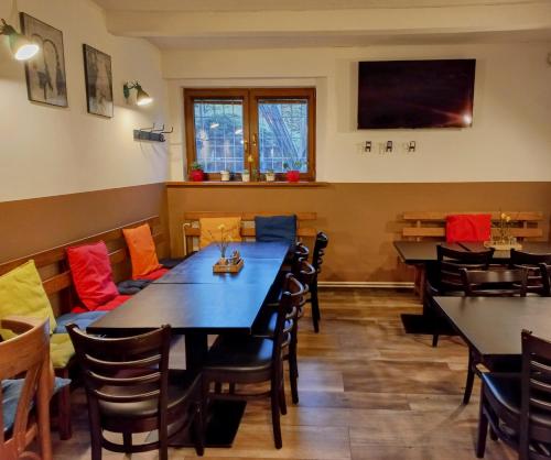 a restaurant dining room with tables and chairs at Penzion Bezděkov in Rakovník