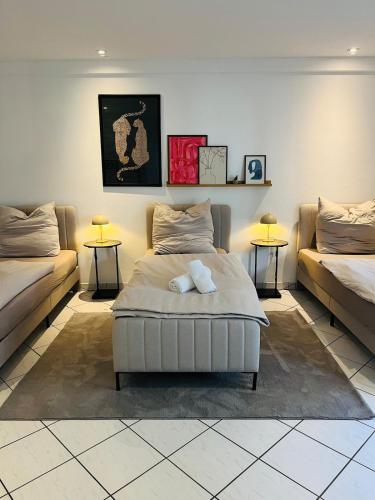 a bedroom with two beds and two tables at OVERNIGHT No5 - Bungalow, Billard, Dart, Kamin in Hannover