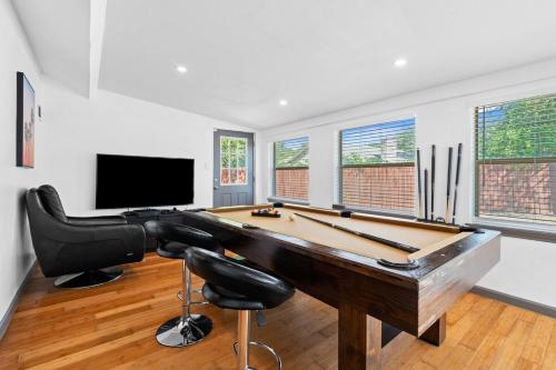 a room with a pool table and a tv at Spacious 4BR w Fenced Yard in Round Rock