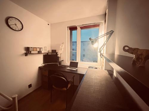 ein Büro mit einem Schreibtisch, einem Laptop und einem Fenster in der Unterkunft Apartament w sercu Karkonoszy in Jelenia Góra