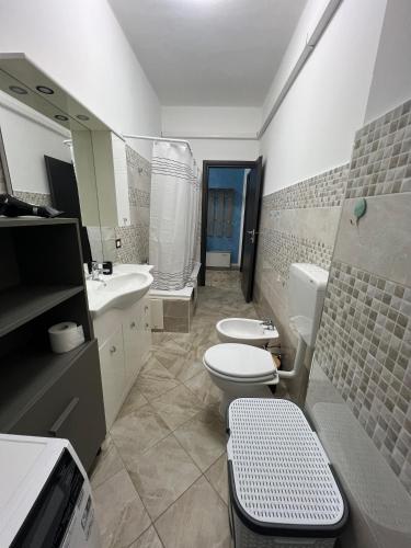 a bathroom with two toilets and a sink at Relax suite in Alessandria