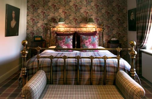 a bedroom with a bed with a plaid blanket at Romantik B&B Zonnehuis in De Haan