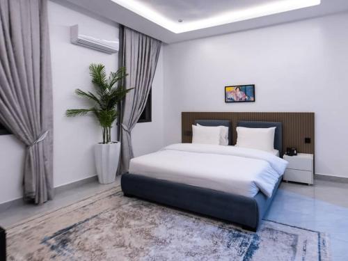a bedroom with a large bed in a room at Aurum on Missouri in Abuja