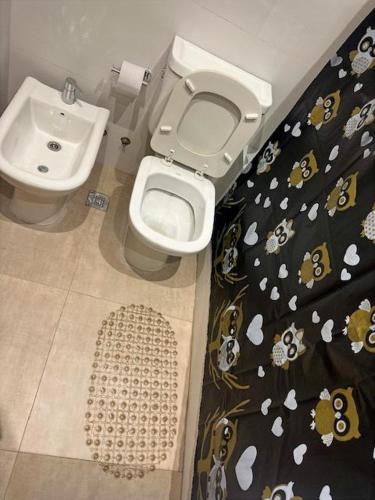 a bathroom with a toilet and a sink at Suipacha Boutique in Buenos Aires