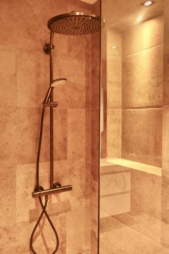 a shower with a glass door in a bathroom at ONE Mambo Number 12 Beach Apartment in Willemstad