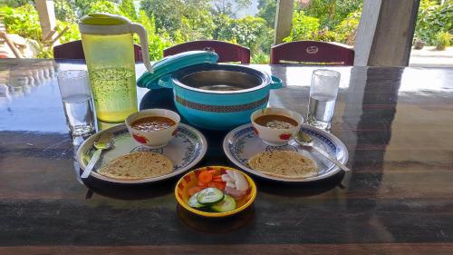 a table with three plates of food on a table at Nimbus Soulstay in Kalimpong