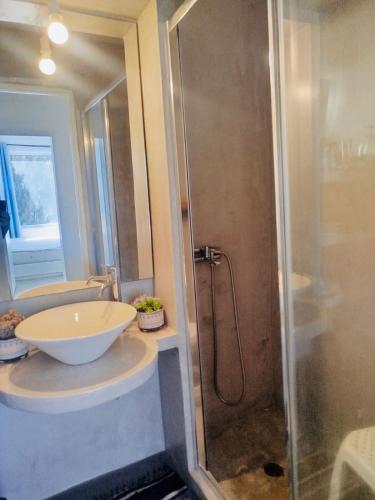 a bathroom with a sink and a shower at Vista Tinos in Triandáros