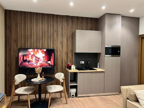 a kitchen with a table and a tv on the wall at Brianza Home in Giussano