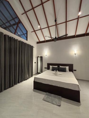a bedroom with a large bed in a room at Rock Harmony Villa in Hikkaduwa