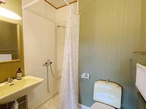 een badkamer met een douche, toilet en wastafel bij 4 star holiday home in VISBY in Visby