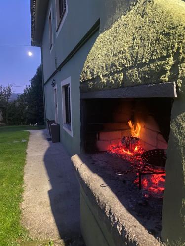 a brick oven with a fire inside of it at Casa Vilamarín in Santa Eulalia