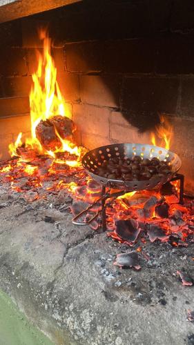 a grill with a fire in a brick oven at Casa Vilamarín in Santa Eulalia