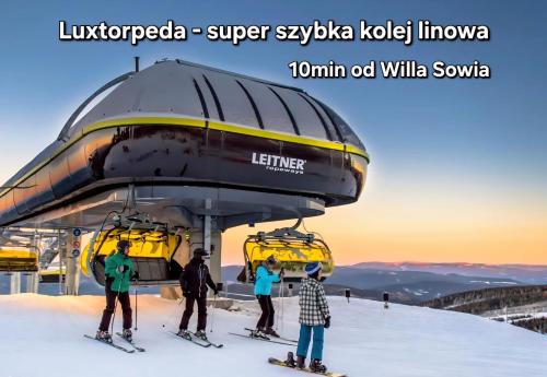 a group of people on skis in a ski lift at Willa Sowia nowe apartamenty nad górskim potokiem zachwycający widok na góry in Stronie Śląskie
