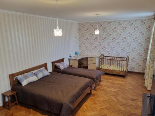 a bedroom with two beds and a crib in it at Felicità Family Club 
