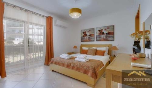 a bedroom with a bed and a desk and a window at Beachside oasis with Pool in Luz