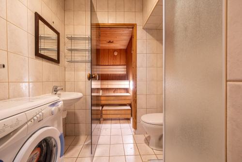 a bathroom with a washing machine and a toilet at Old Town - Best Location Apartment in Tallinn