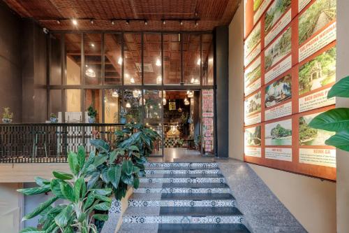 a hallway with plants in front of a building at Tam Coc Lion Kings Hotel & Resort Ninh Binh in Ninh Binh