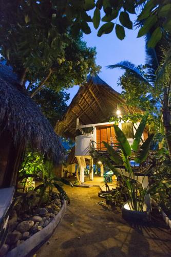 a resort with a building with trees and plants at Bambú Ecocabañas in San Agustinillo