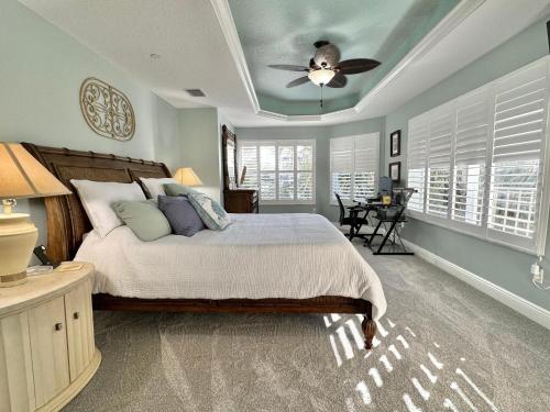 a bedroom with a bed and a ceiling fan at Chateaus on White Sands 302 in Clearwater Beach